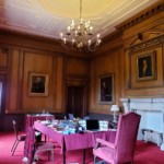 red themed castle room with a table in the middle