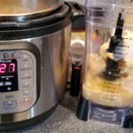 blend filled with cauliflower next to instapot
