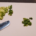 green onions chopped on a cutting board